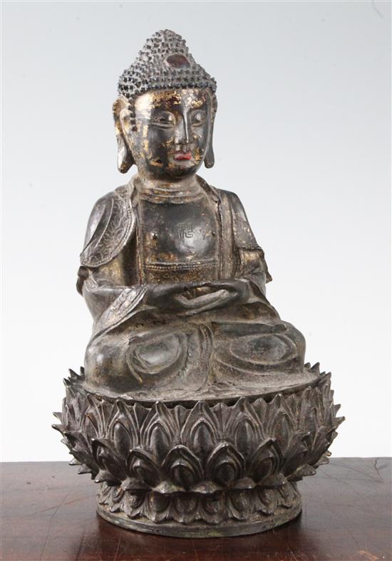 A Chinese lacquered bronze seated figure of Buddha Shakyamuni, Ming dynasty, 16th/17th century, height 28cm